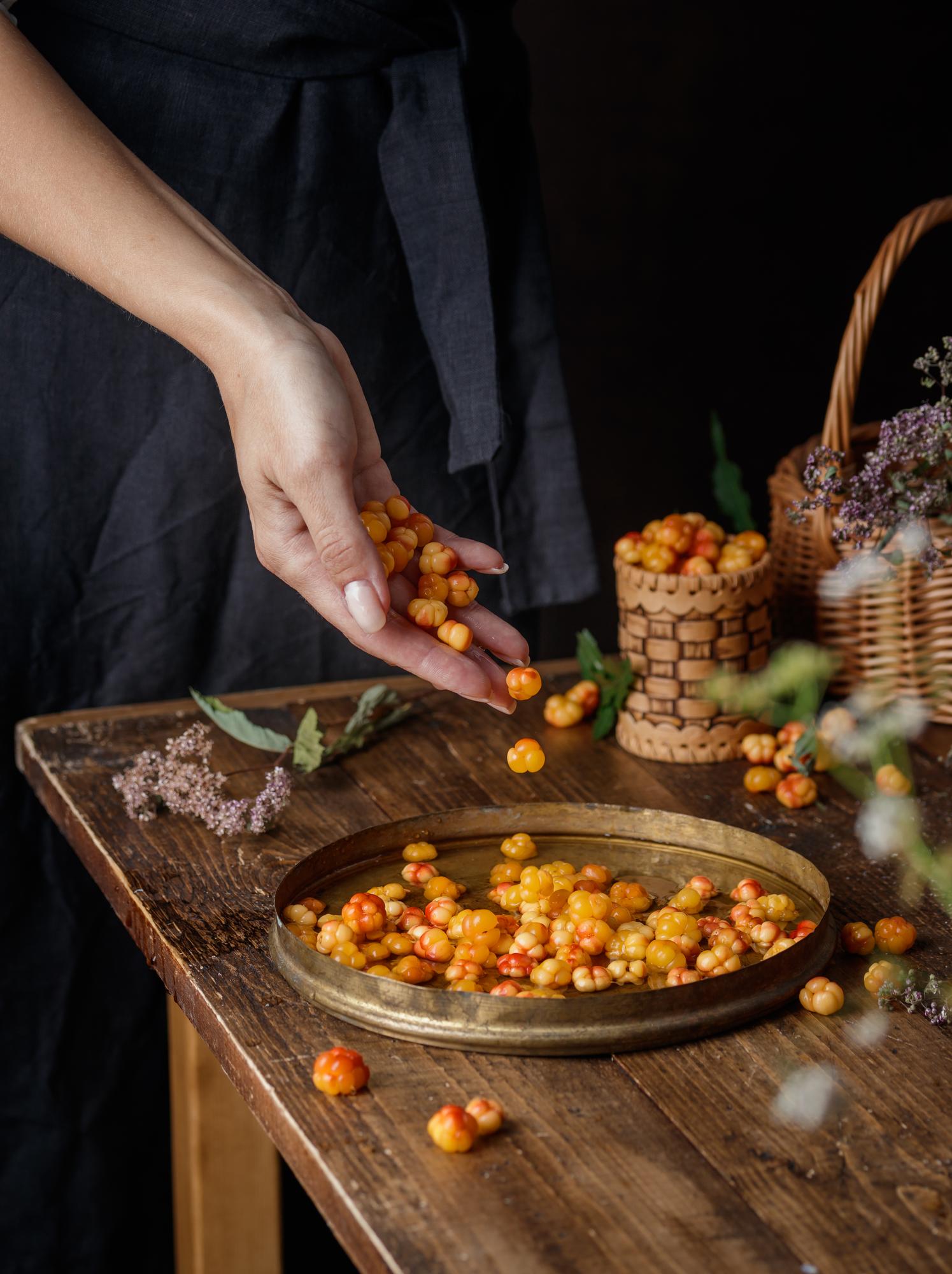 Chef arranges seasonal plates on wooden table